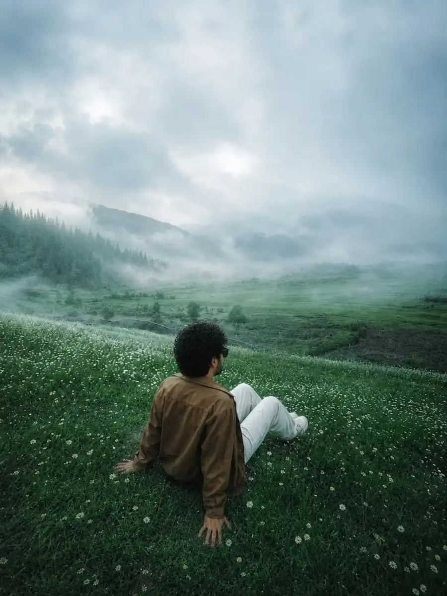 Chatgpt BoysYoung Man Sitting On A Green Field  Prompts - AI photo editing prompt image
